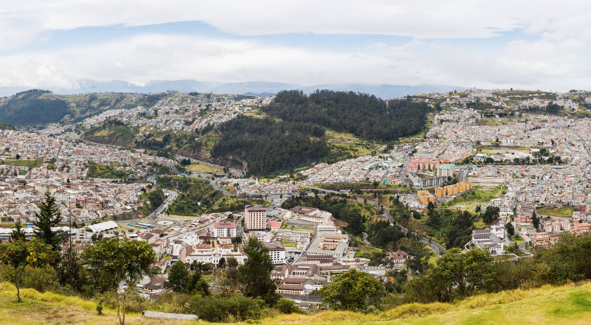 A panoramic view of Quito spread across the Andean basin, seen from the El Panecillo overlook